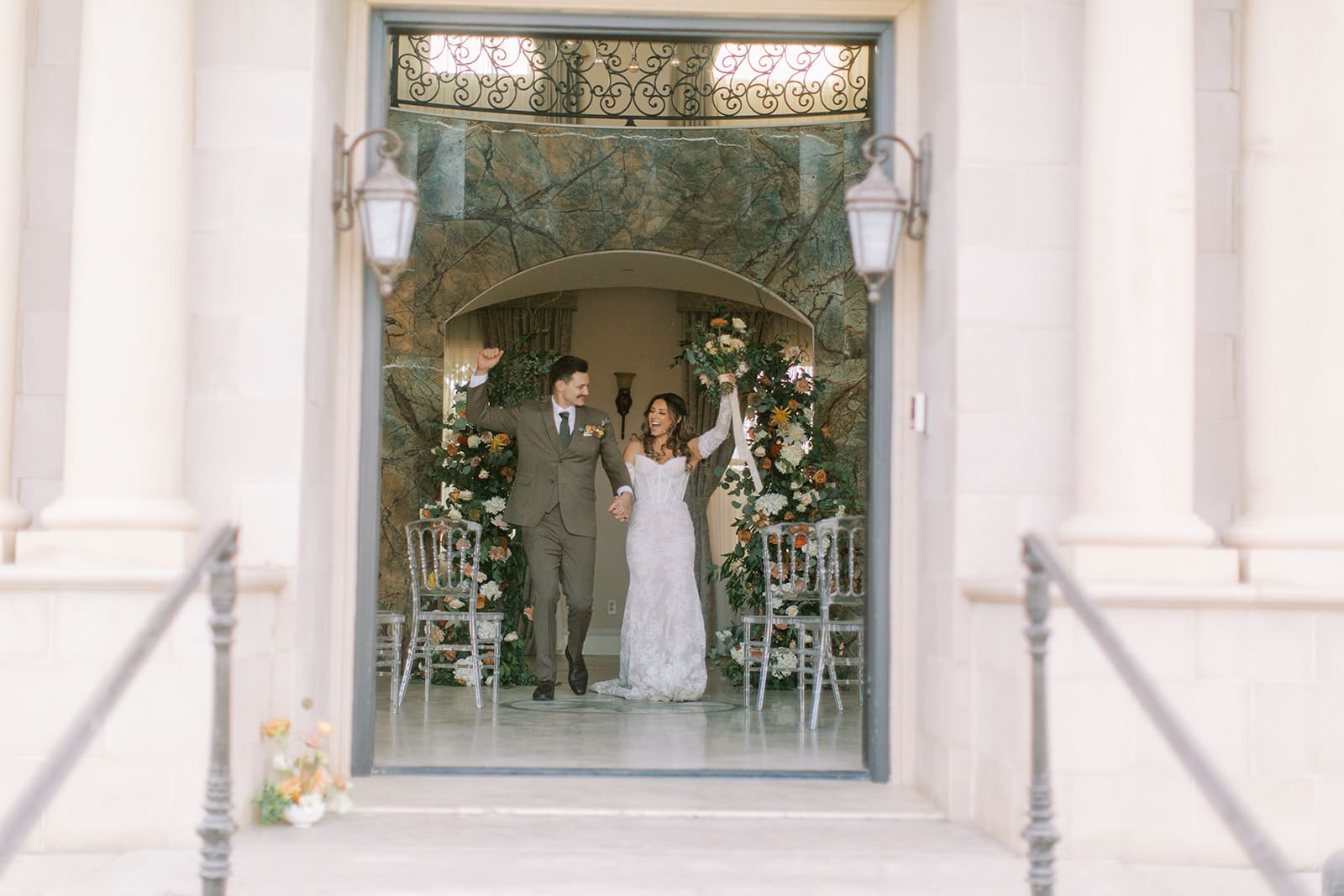 A bride and groom exit the venue after having just been married.